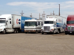 A 28 foot motorhome  with a towed Saturn wagon may seem big, until it is parked between the "real" big rigs.