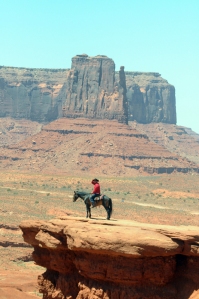 This view of the cowboy and horse is from John Ford Point. John Ford filmed many westerns in Monument Valley.